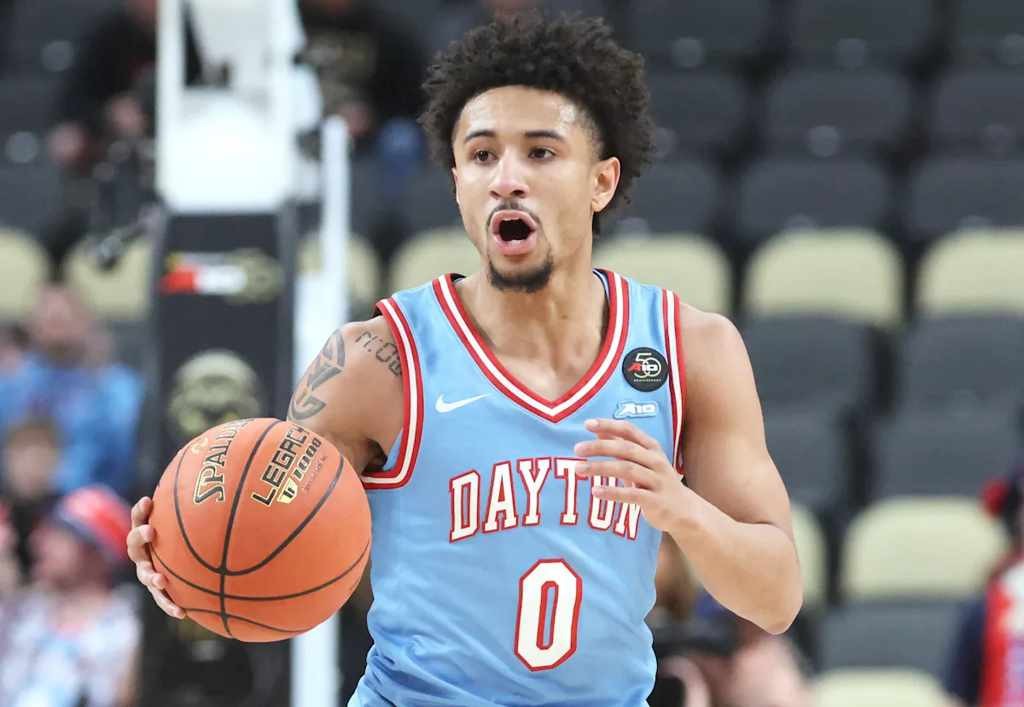 Supporting Dayton over UNC Wilmington is for those who value local pride over national recognition. - Slide 1